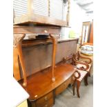 A mahogany finish bow front dressing table, with central drawer, flanked by two further drawers on