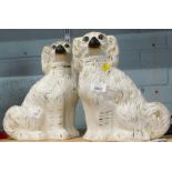 A pair of Staffordshire flat back figures of spaniels, picked out in gilt, 28cm high.