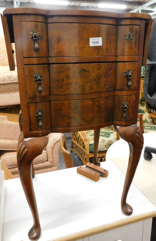 A 20thC walnut drop leaf side table, with shaped drawers each with tier drop handles on cabriole