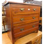 An Edwardian oak chest of three long drawers, with plate back handles.
