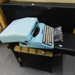 An Imperial 200 typewriter, in blue colour way, 32cm wide when case closed, piano stool, etc. (a