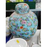 A 20thC Chinese pottery jar and cover, of globular form, decorated with flowers, on a turquoise
