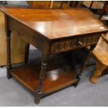 An oak Ercol style side table, of shaped form with frieze drawer on turned legs joined by an under