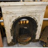 A Victorian cast iron fireplace, of rectangular form, with arched opening and pierced fixed grate,
