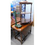 An oak barley twist gateleg table, on elongated orb feet, 70cm high, a cast iron umbrella stand, and
