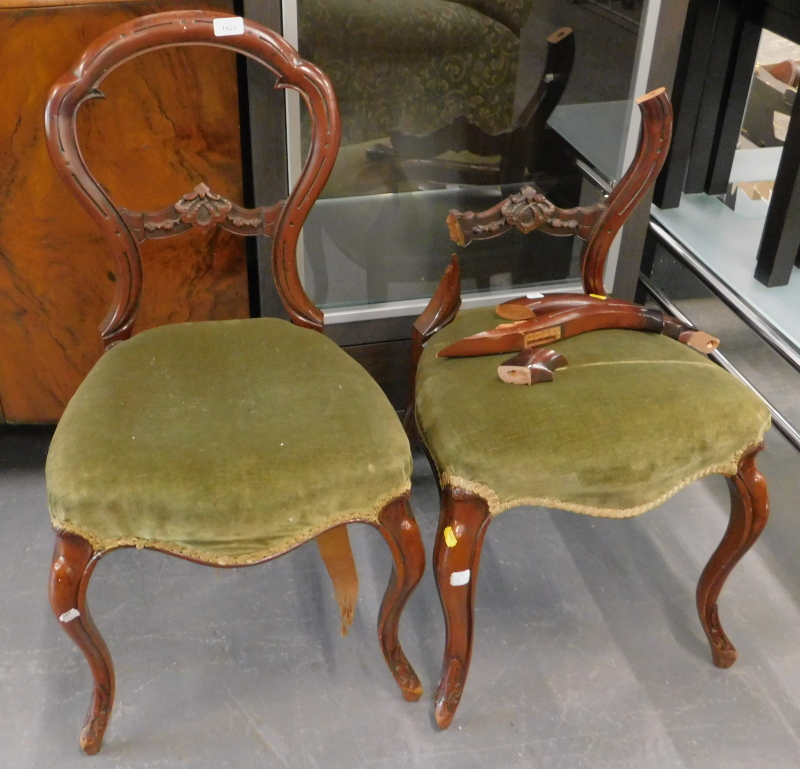 A pair of Victorian mahogany balloon back chairs, each with a green upholstered padded seat on