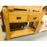 An oak two drawer side cabinet, with under tier.