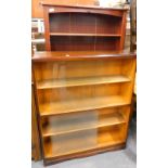 A stained pine open bookcase, and an oak bookcase with sliding doors, 90cm wide.