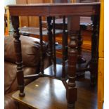 An Edwardian mahogany two tier occasional table on turned legs.