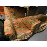 Two armchairs in floral material, 93cm wide, with serpentine backs, raised front seats and block