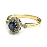 A 9ct gold cluster ring, the central cluster set with white and blue stone, each in claw setting wit