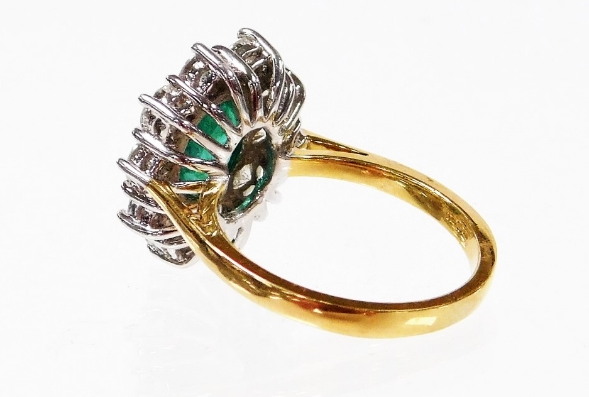 An 18ct gold emerald and diamond cluster ring, with oval cut emerald 8.6mm x 6.6mm x 3.8mm, totallin - Image 2 of 2