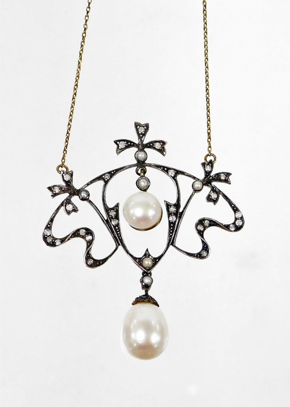 An ornate diamond and pearl necklace, in Belle Epoque style with bows and sprays, set with tiny diam - Image 2 of 3