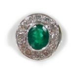 An 18ct white gold oval emerald and diamond cluster ring, set with oval cut emerald 1.70cts, surroun