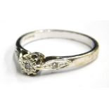 A 9ct white gold diamond set dress ring, with tiny illusion set diamond to centre and a tiny diamond