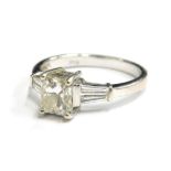An 18ct white gold diamond dress ring, with central rectangular cut diamond measuring 5.6mm x 4.8mm