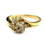 A 9ct gold dress ring, floral design with twist shoulders, set with tiny white stones, makers stamp