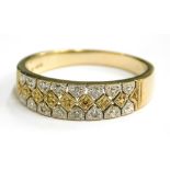 A 9ct gold half hoop eternity ring, set with an arrangement of white and yellow metal, gradually set