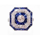 A sapphire and diamond dress ring, with chamfered edges, set with a central diamond, 4.6mm x 4.6mm x