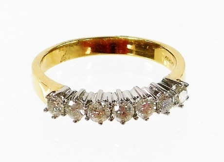 An 18ct gold half hoop diamond eternity ring, set with seven round brilliant cut diamonds, each in c