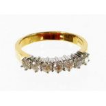 An 18ct gold half hoop diamond eternity ring, set with seven round brilliant cut diamonds, each in c