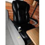 A black leatherette office chair with metal frame.