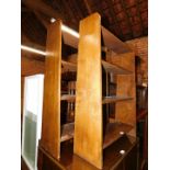 A pair of stained oak waterfall bookcases, each 92cm high, 61cm wide, 23cm deep.