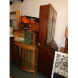 An oak 1950's cocktail cabinet, 131cm high, 95cm wide, 37cm deep, together with an oak bureau