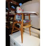 A late 20thC beech child's Mothercare metamorphic high chair, converts from high chair to table/