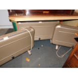 Three matching mid 20thC Warmflow electric heaters, Mfd by C F Taylor, model 1/1500, each 59cm high,