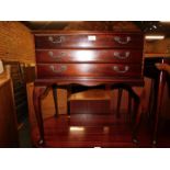 A reproduction mahogany three drawer canteen, baize lined and raised on cabriole legs, 68cm high,