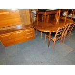 A teak G-Plan extending dining table, together with four Schreiber dining chairs, and a Schreiber