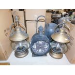 A pair of battery operated tilly type lamps, together with a Quartz lantern clock. (3)