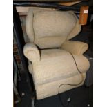 An electric rise recliner armchair, upholstered in beige chenille fabric.