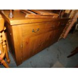 A chunky pine sideboard, with three drawers above three cupboard doors, 87cm hihg, 150cm wide,