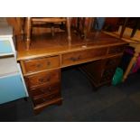 A reproduction mahogany twin pedestal desk, with brown tooled leather top, 77cm high, 123cm wide,