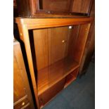 A late 20thC teak veneered glazed bookcase, enclosing two adjustable shelves and lower cupboard,