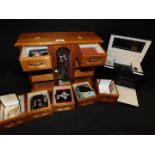 A wooden jewellery cabinet, containing assorted costume jewellery, together with a Dulwich Designs