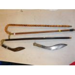 Two brass topped walking sticks, a bamboo walking stick and two Kukris. (5)
