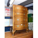 A mid 20thC walnut serpentine chest, of two over three drawers, raised on cabriole legs, 78cm