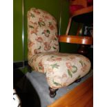 A Victorian mahogany nursing chair, with scroll seat raised on turned legs.