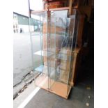 A pair of glass display cabinets enclosing three shelves, 164cm high, 43cm wide, 37cm deep.