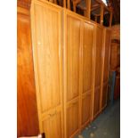 A teak effect five section wardrobe set, 209cm high, 184cm wide, 54cm deep.