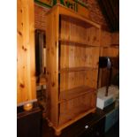 A pine bookcase enclosing three adjustable shelves, 134cm high, 75cm wide, 27cm deep.