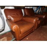 A pair of brown leather armchairs.