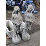 A pair of reconstituted stone maidens dressed in togas.