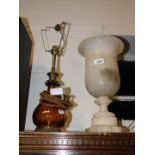 An alabaster urn, converted into a table lamp, 35.5cm high, together with a brass and amber glass