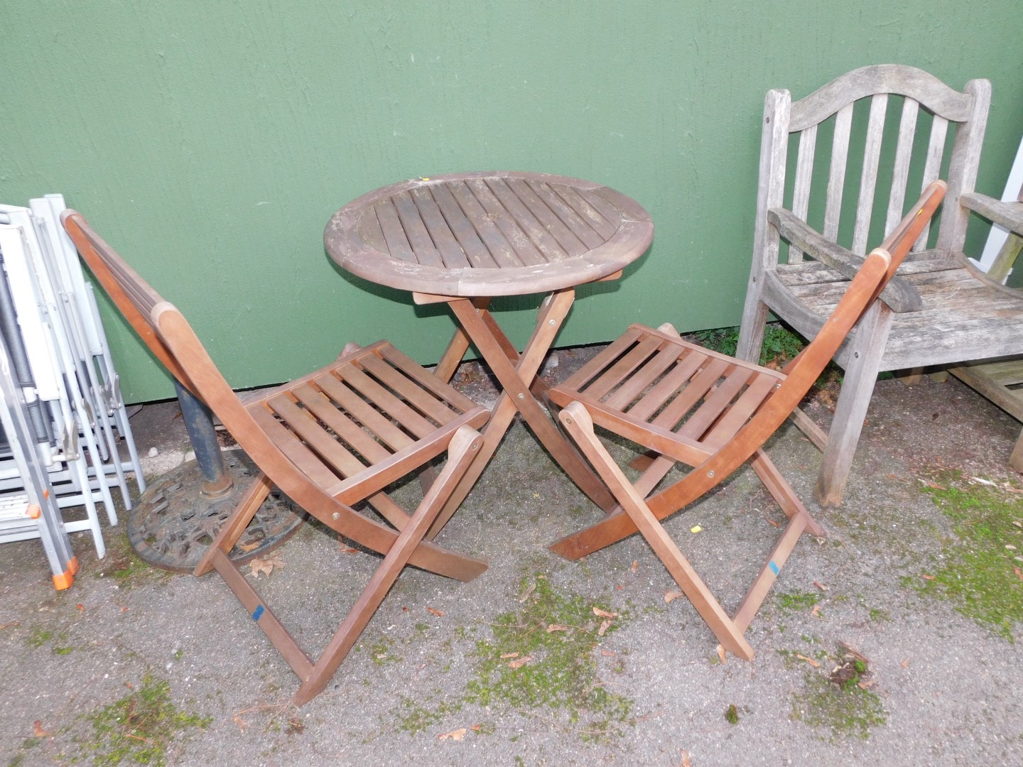 A teak patio table and two chairs. (3)