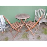 A teak patio table and two chairs. (3)