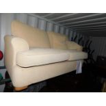 A cream fabric two seater sofa bed.